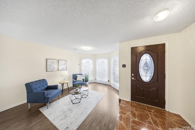 entrance foyer featuring a textured ceiling and dark hardwood / wood-style floors