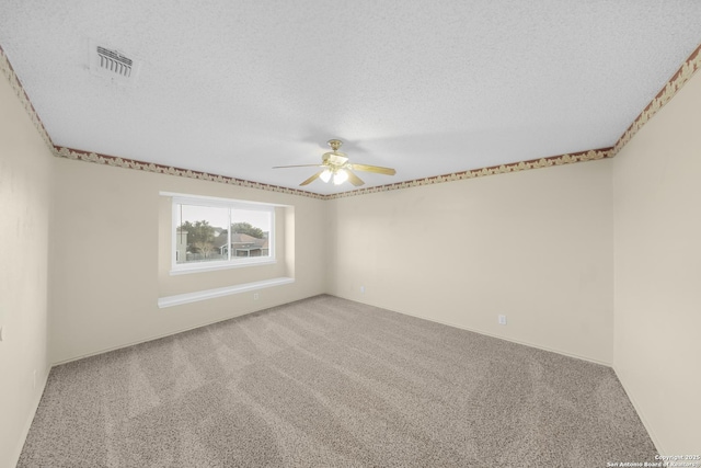 carpeted empty room featuring ceiling fan and a textured ceiling