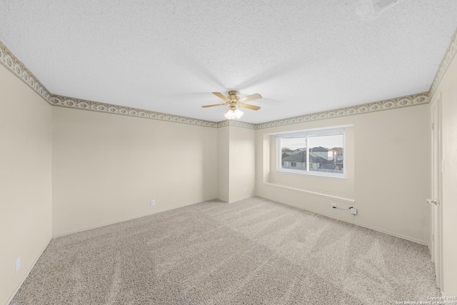 carpeted spare room featuring a textured ceiling and ceiling fan