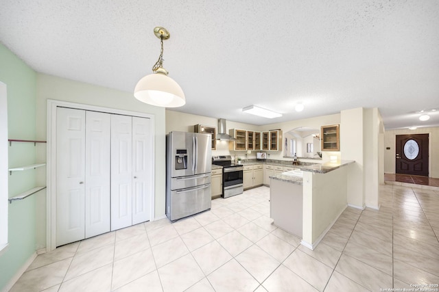 kitchen with kitchen peninsula, appliances with stainless steel finishes, hanging light fixtures, light stone countertops, and wall chimney range hood