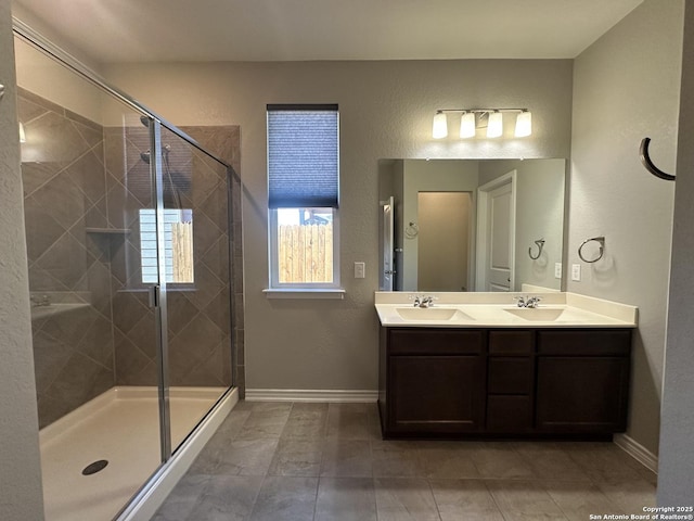 bathroom featuring an enclosed shower, vanity, and tile patterned flooring