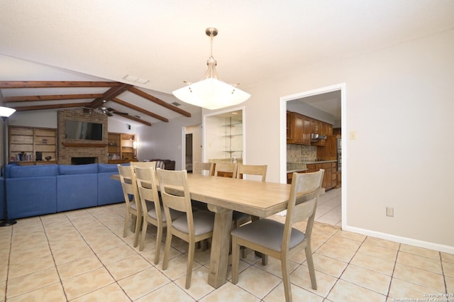 dining room featuring vaulted ceiling with beams and light tile patterned floors