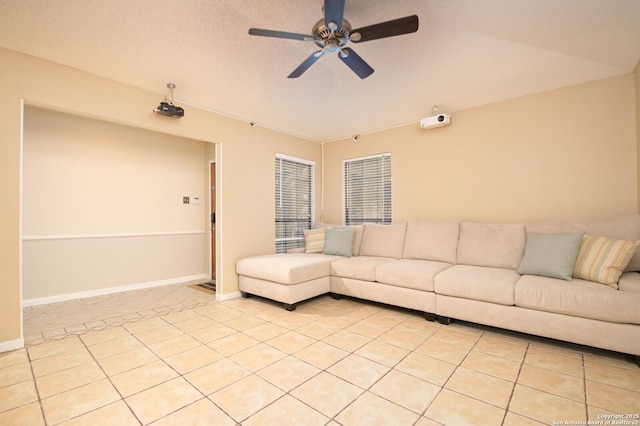 unfurnished living room featuring a textured ceiling, ceiling fan, and light tile patterned floors