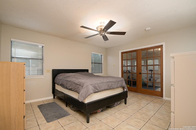 bedroom with a textured ceiling, ceiling fan, light tile patterned flooring, and french doors