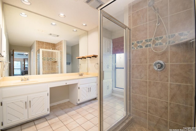 bathroom with ceiling fan, tile patterned flooring, vanity, and a shower with door