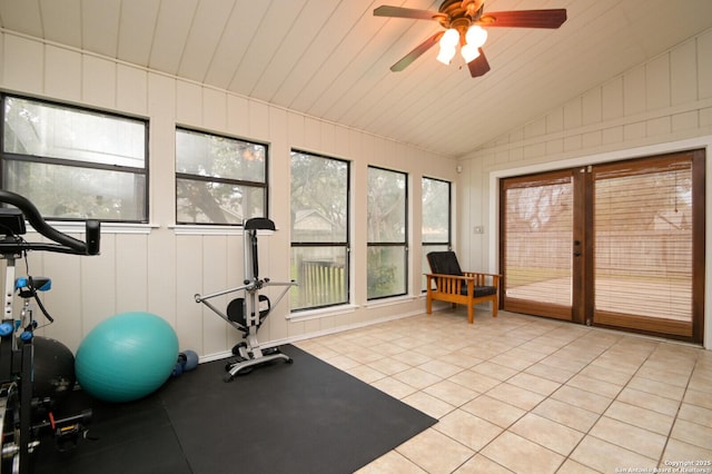 workout room with ceiling fan, light tile patterned floors, french doors, and vaulted ceiling