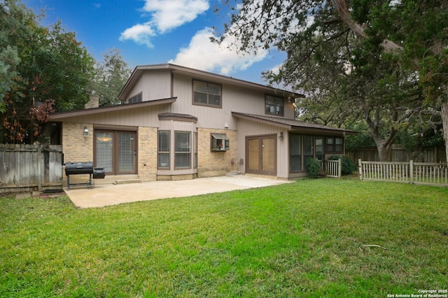 back of property featuring a yard and a patio