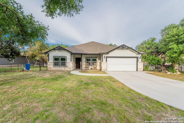 view of front of house with a front yard and a garage