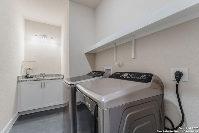 laundry room with washing machine and clothes dryer and sink