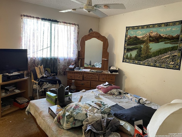 bedroom with ceiling fan, multiple windows, and a textured ceiling