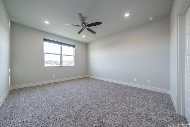 empty room with ceiling fan and carpet flooring