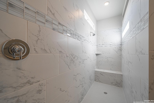 bathroom with a tile shower