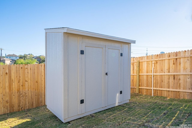 view of outbuilding with a yard