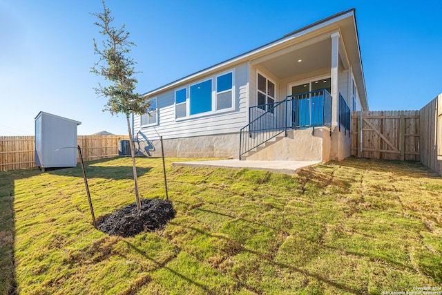 rear view of house with a yard