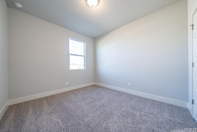 unfurnished room featuring carpet floors and lofted ceiling