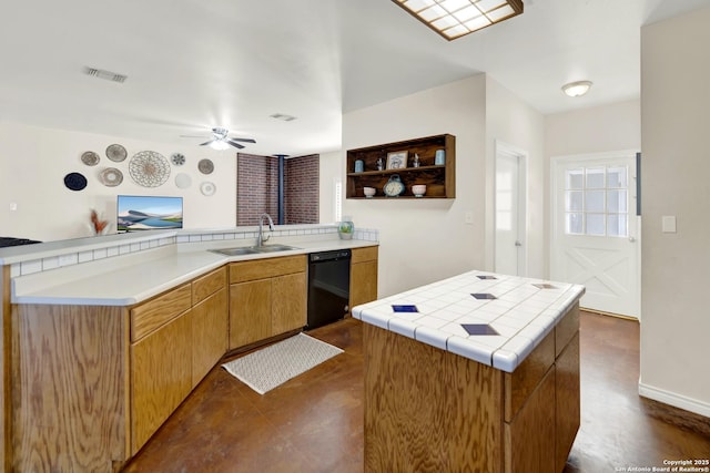 kitchen with a kitchen island, black dishwasher, sink, kitchen peninsula, and ceiling fan