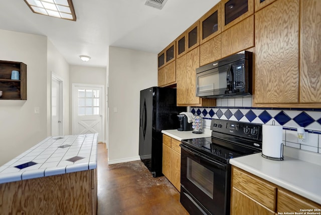 kitchen featuring black appliances and decorative backsplash