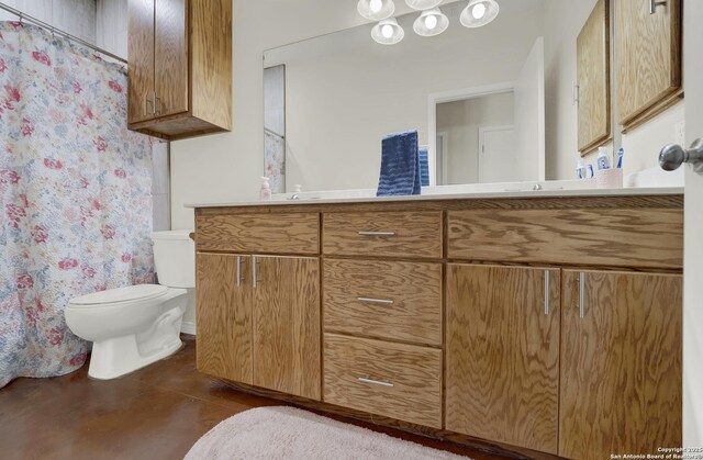 bathroom with concrete floors, toilet, vanity, and a shower with curtain