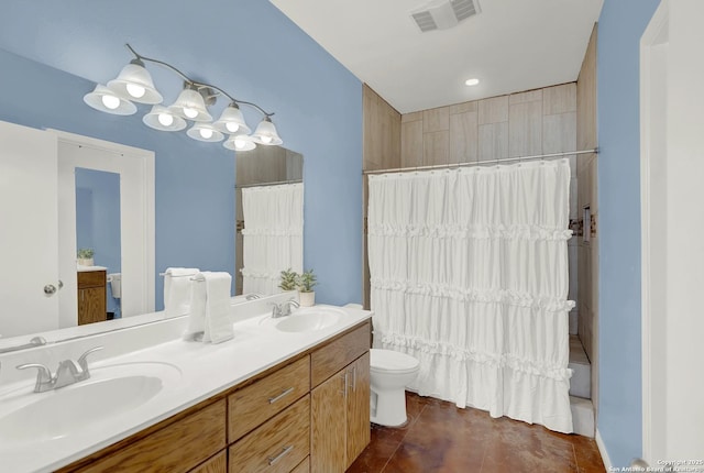 full bathroom with shower / bath combo with shower curtain, tile patterned floors, toilet, and vanity