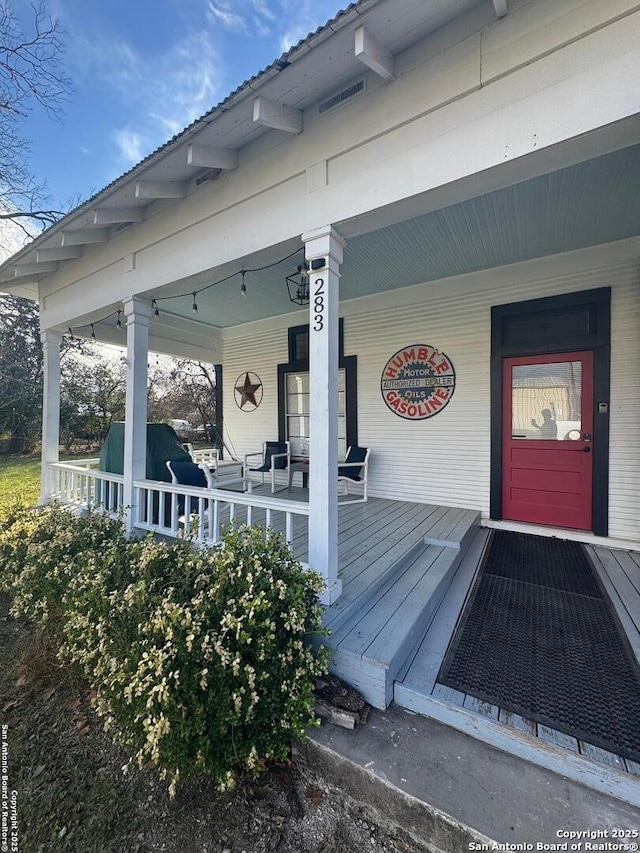 doorway to property with a porch