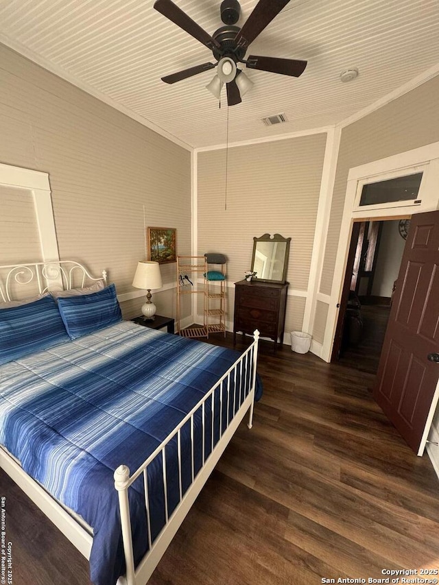 bedroom with ceiling fan, ornamental molding, and dark hardwood / wood-style floors