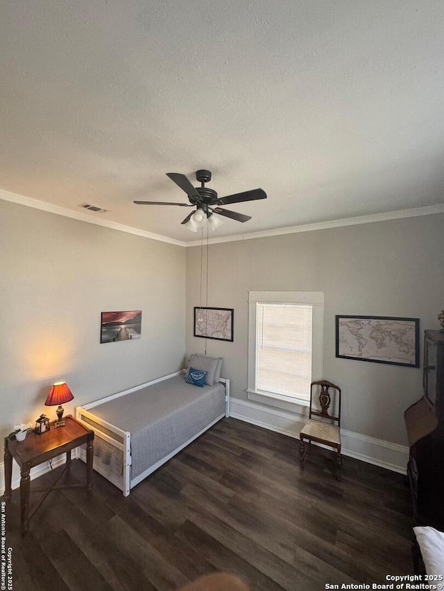 bedroom with ceiling fan, a textured ceiling, dark hardwood / wood-style floors, and ornamental molding