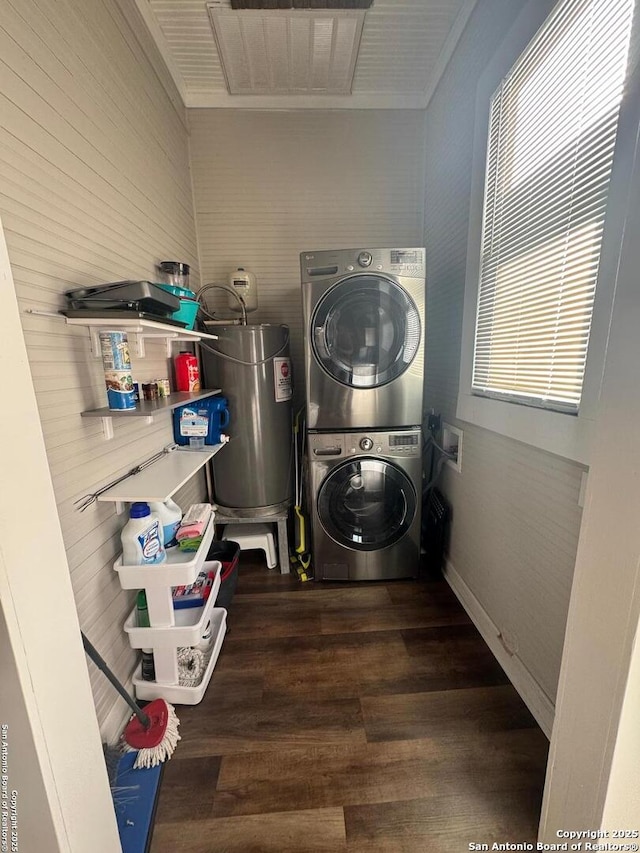 laundry area with stacked washer / dryer, dark wood-type flooring, and ornamental molding