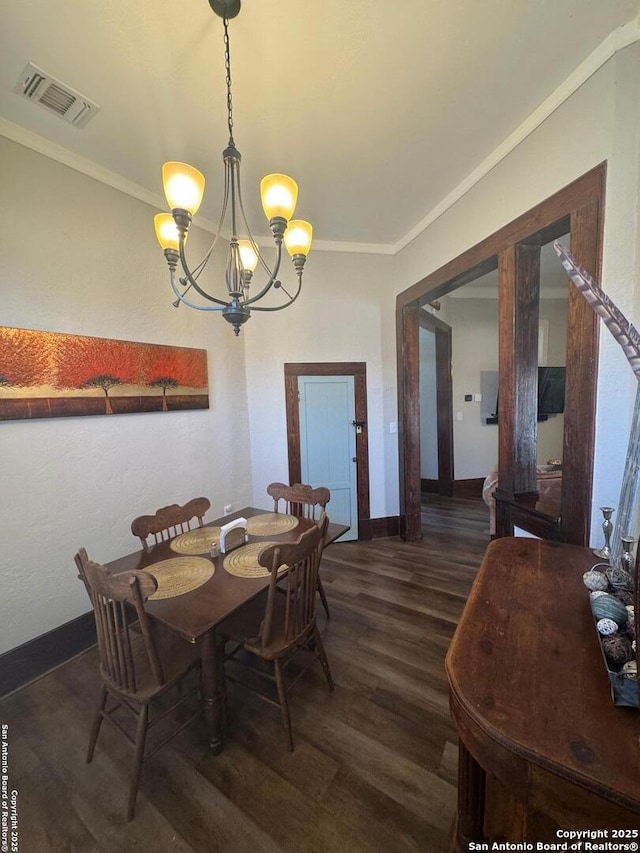 dining area with a notable chandelier, dark hardwood / wood-style flooring, and ornamental molding