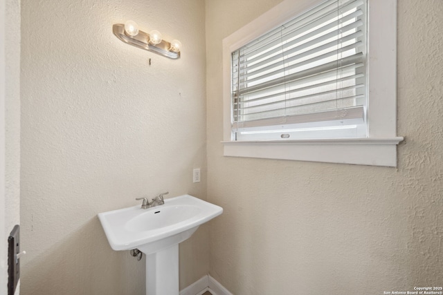 bathroom featuring a textured wall