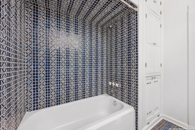 bathroom with baseboards and  shower combination
