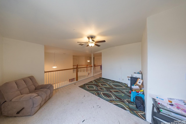 living room with ceiling fan, carpet, and lofted ceiling