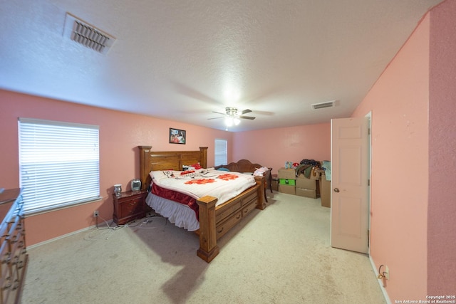 carpeted bedroom featuring a textured ceiling and ceiling fan