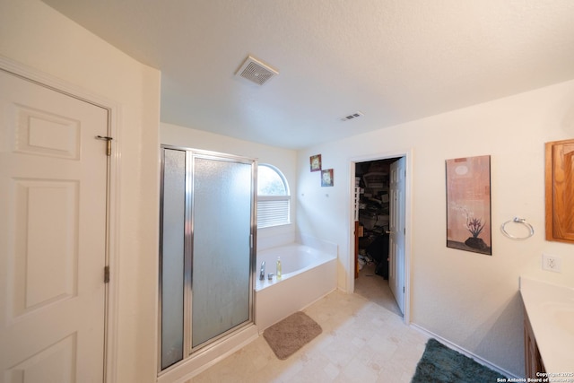 bathroom with vanity and plus walk in shower