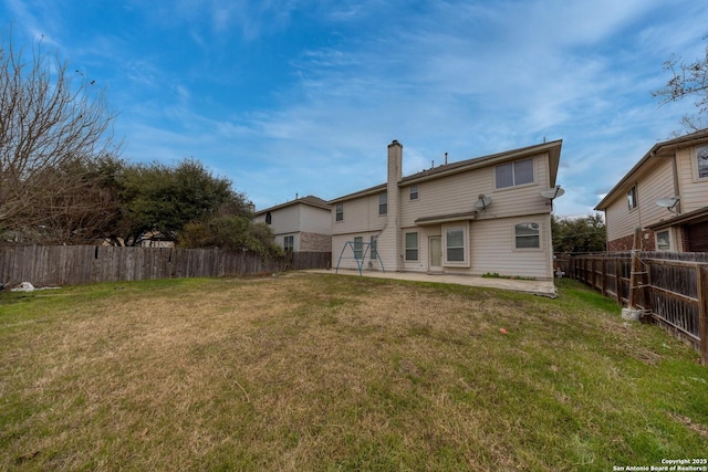 back of property featuring a patio area and a lawn