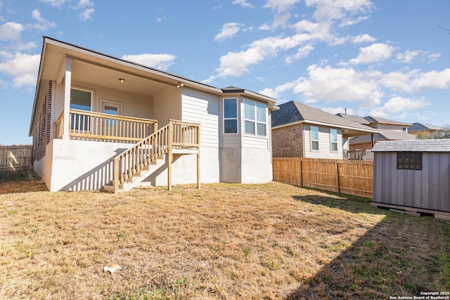 back of property with a shed and a lawn