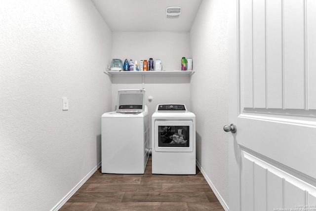 laundry area with dark hardwood / wood-style flooring and washing machine and clothes dryer