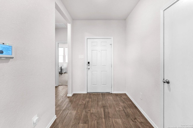 hallway with dark hardwood / wood-style floors