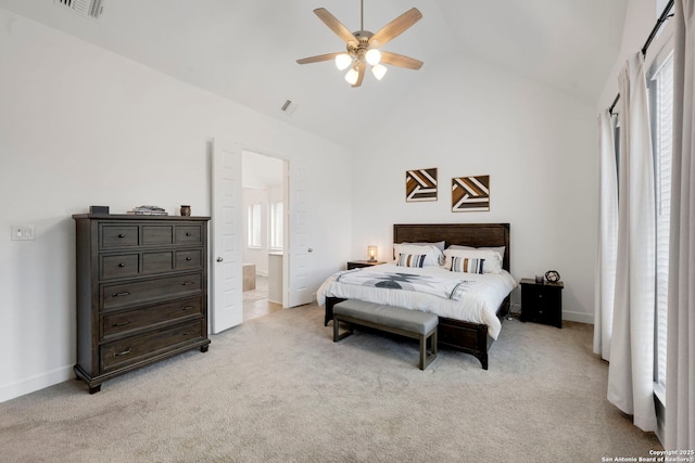 carpeted bedroom featuring ceiling fan, ensuite bathroom, and vaulted ceiling