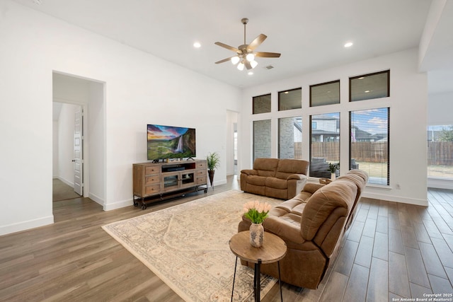 living room featuring hardwood / wood-style floors and ceiling fan