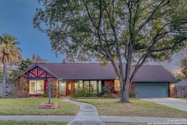 ranch-style house featuring a garage and a lawn