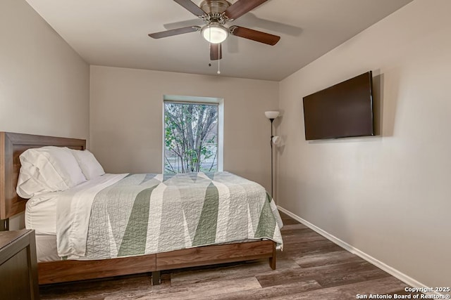 bedroom with ceiling fan and dark hardwood / wood-style flooring