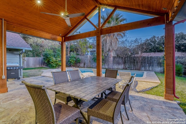 view of patio featuring ceiling fan, a fenced in pool, and grilling area