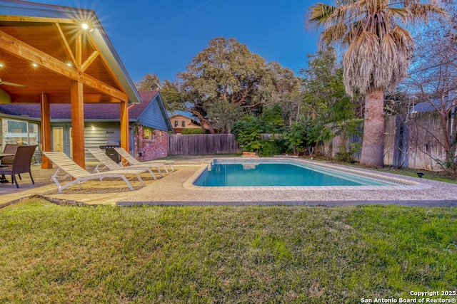 view of pool with a lawn and a patio