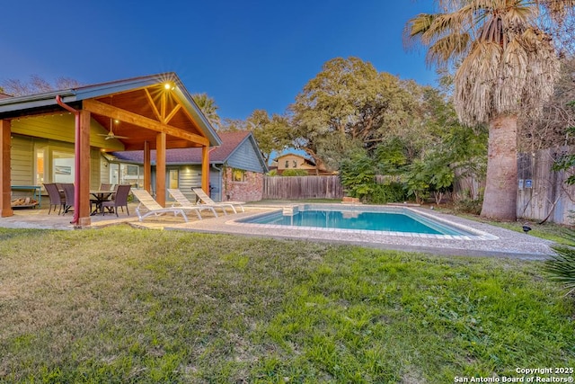 view of swimming pool featuring a yard and a patio