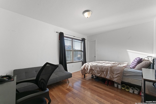 bedroom with dark hardwood / wood-style flooring