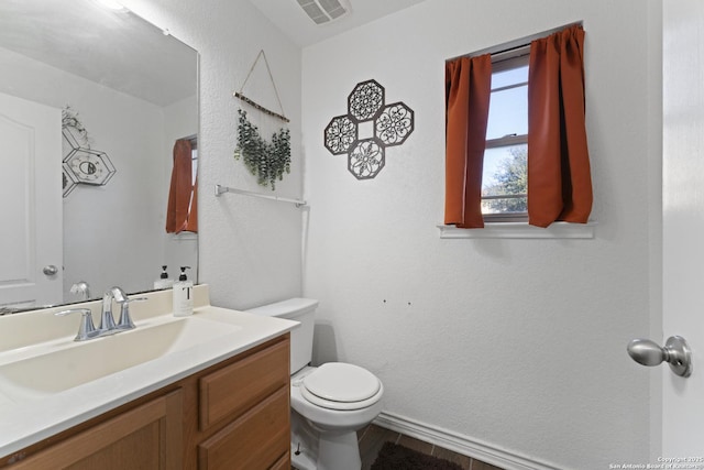 bathroom featuring toilet and vanity