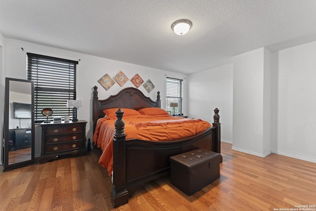 bedroom featuring wood-type flooring and a textured ceiling