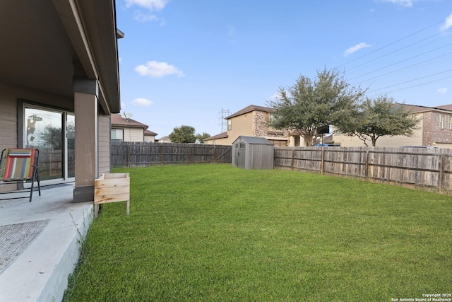 view of yard with a storage shed and a patio