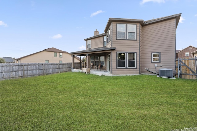 back of property with a lawn, central AC, and a patio