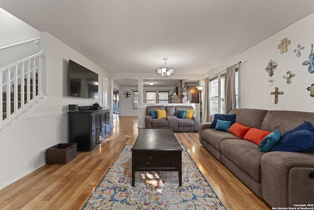 living room featuring light wood-type flooring and a chandelier